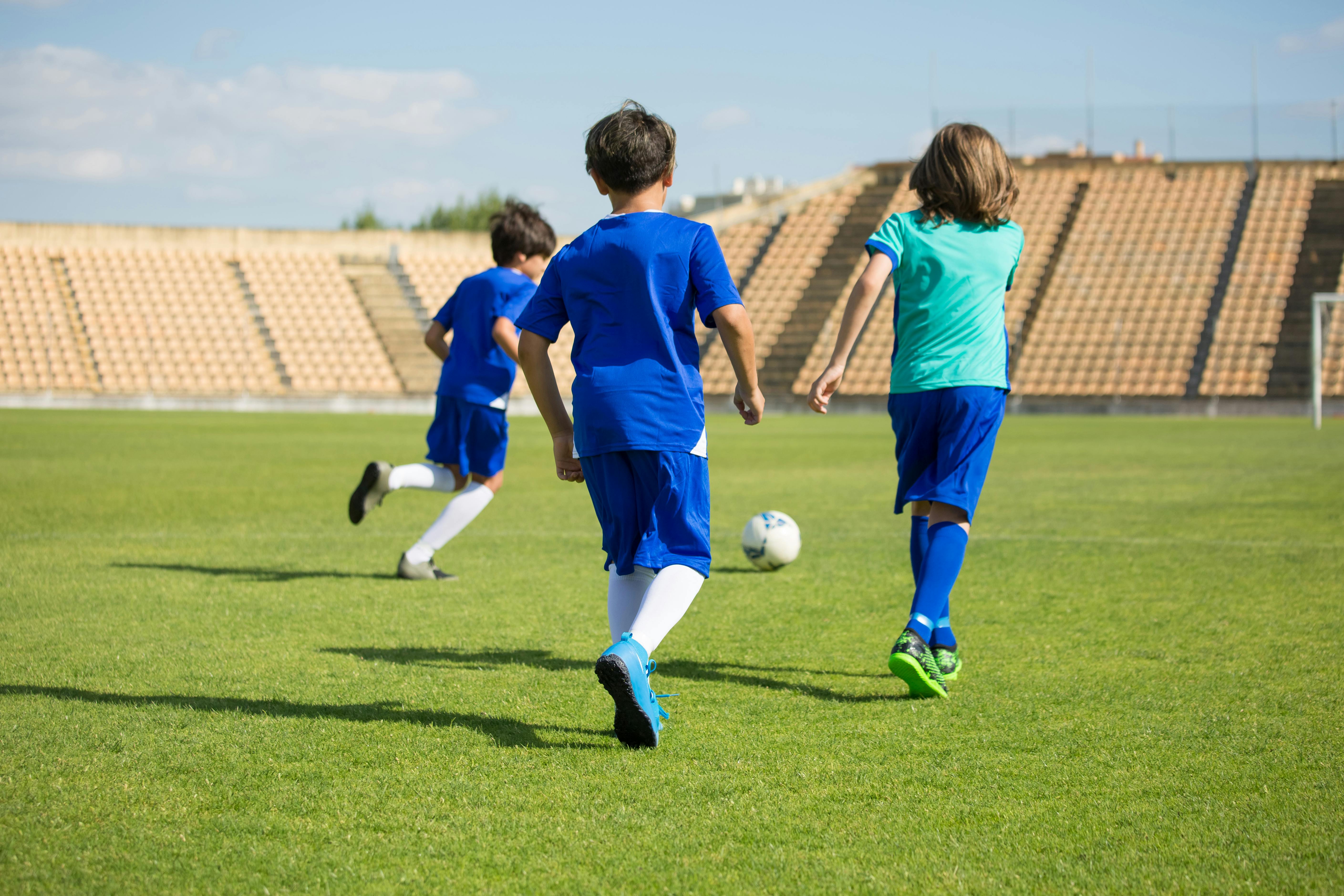 Kids playing soccer on a field